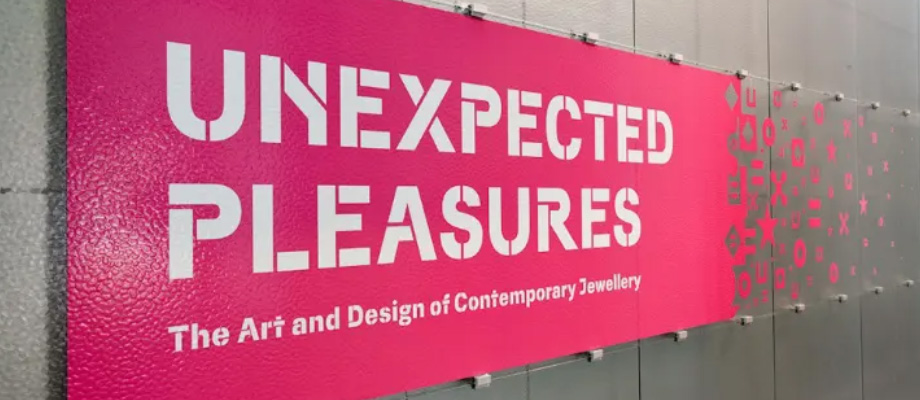 Two black and white photos side by side. On the left, a mother is flanked by two children, but where the two faces should be are a QR code. On the right a mother poses with her child, with the same QR code where the child's face should be